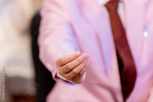 Hand hold diamond ring with blur city background. symbol of wedding, marriage and love. image for background, wallpaper, objects and illustration. © kanpisut