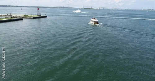 Iconic Newport Rhode Island scenery is enjoyed by a boat load of tourists near Ft. Adams.  4k 60fps photo
