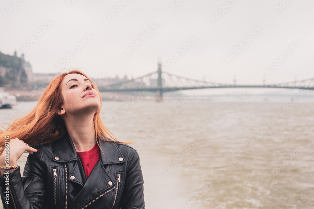 Obraz premium Tourism concept. Beautiful woman look at view of city streets, centre of city . Vacation in Budapest