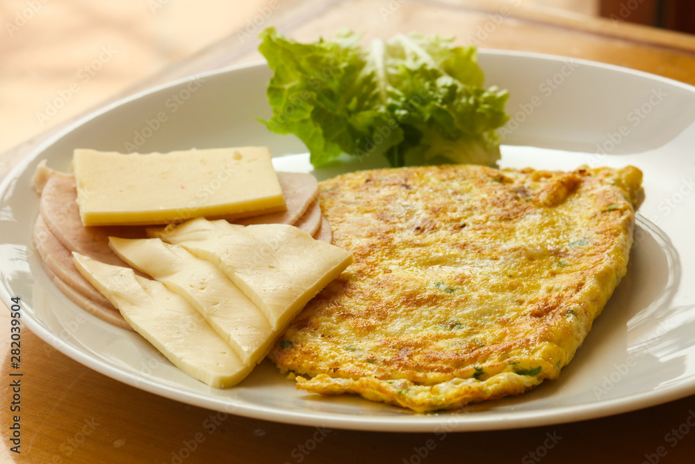 Omelet with cheese and salad