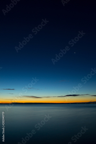 lake and sky with stars before sunrise