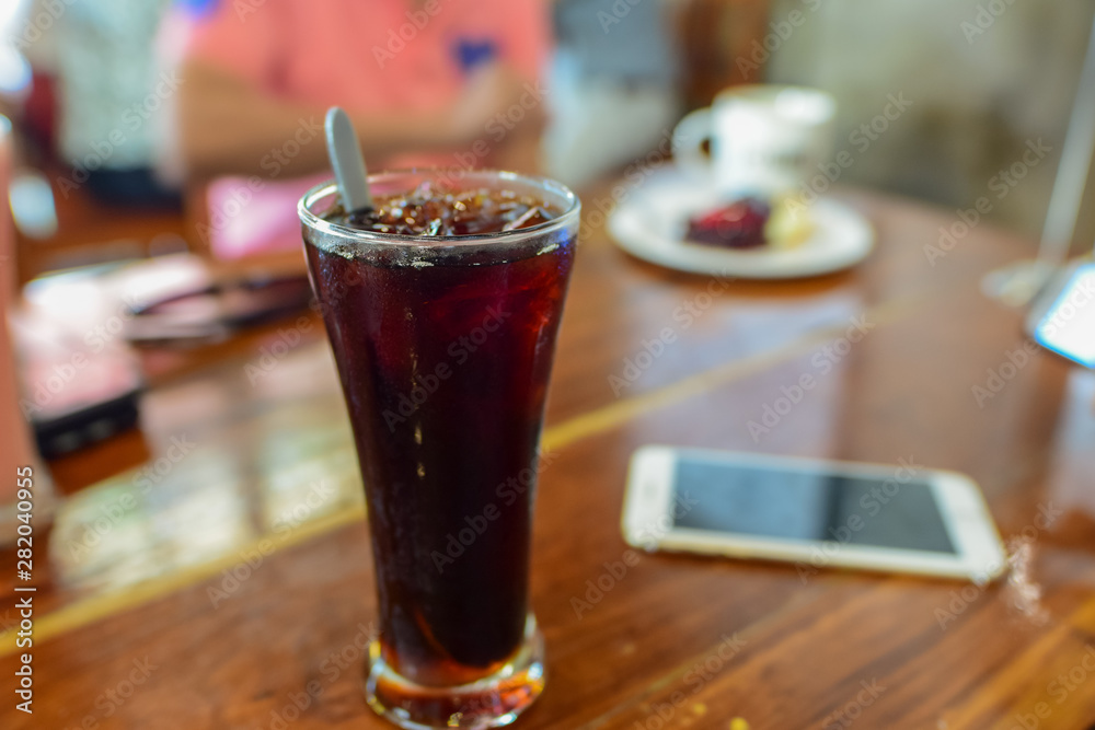 Black coffee, reception table, relaxation with food and drinks, focus on the glass and blur the background Black coffee, reception table, relaxation with food and drinks, focus on the glass and blur the background