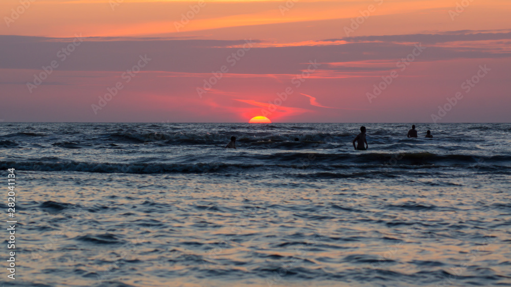 People at the Evening Beach at Sunset Time. People at the Evening Beach at Sunset Time.