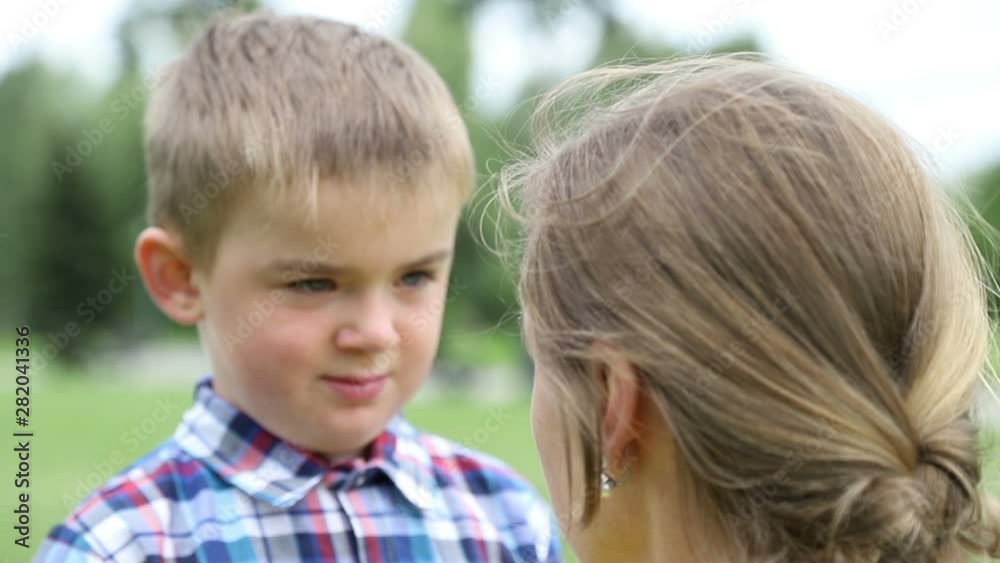Mother scolds son, the child is sad, he bowed his head down. Close-up, slow motion Mother scolds son, the child is sad, he bowed his head down. Close-up, slow motion