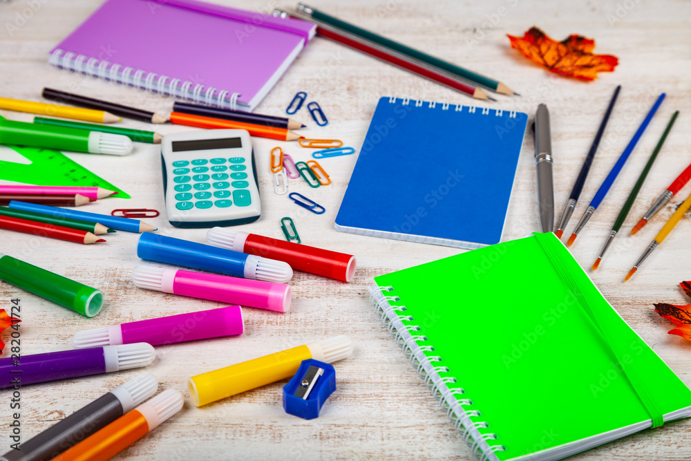 Items for the school on a wooden table.