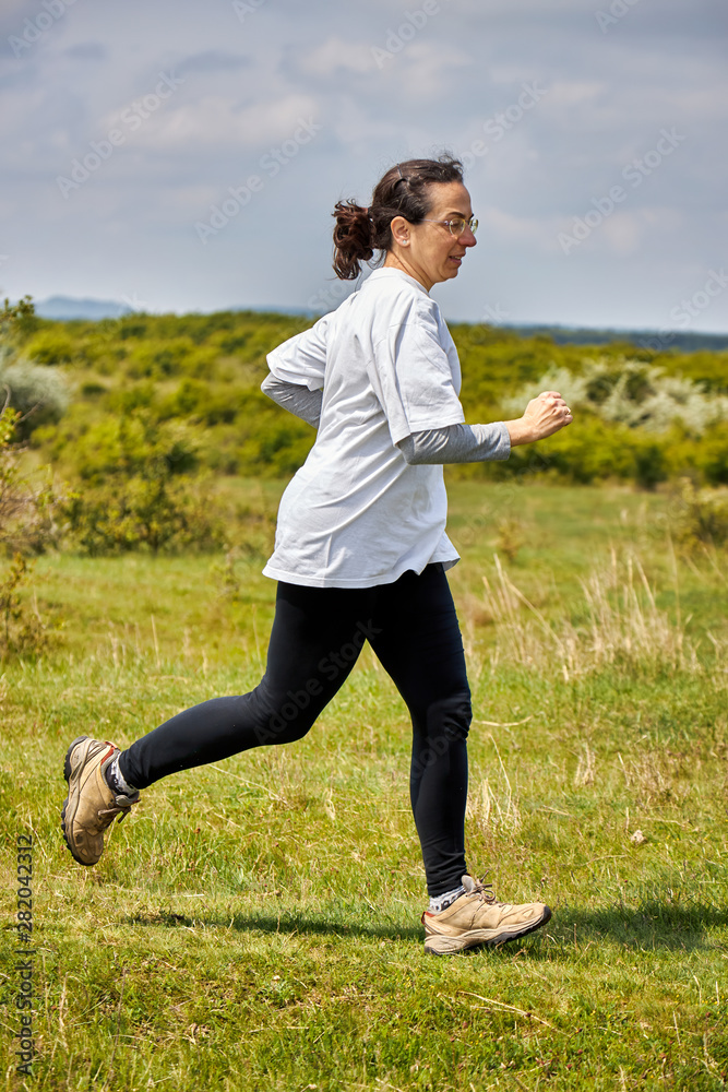 Spanish woman running on meadow Spanish woman running on meadow
