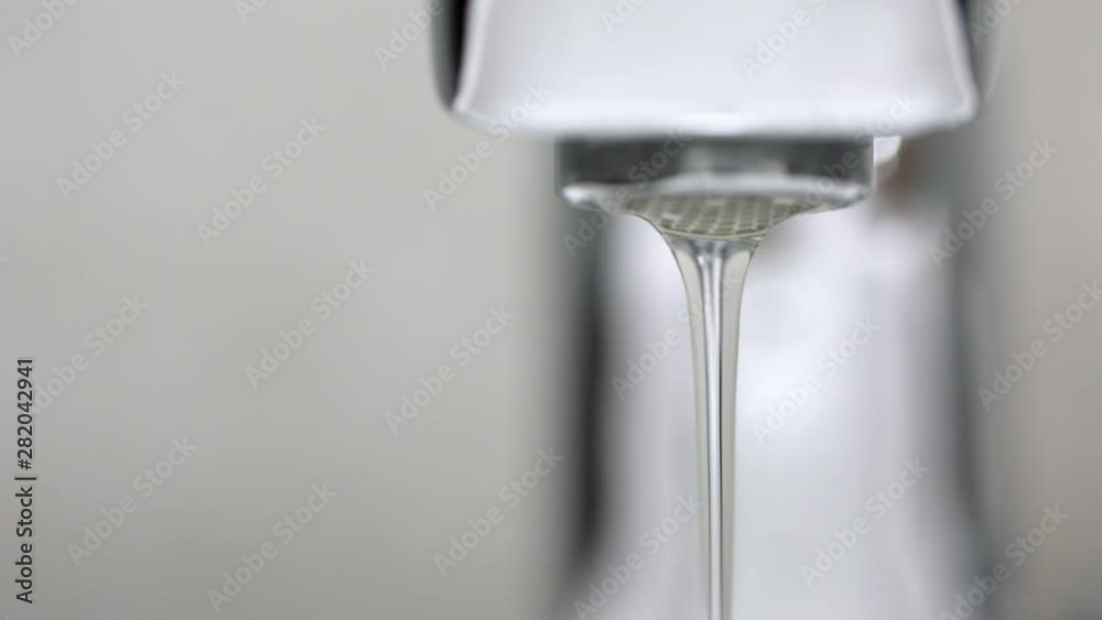 A drop of water dripping from the tap. A drop of water dripping from the tap.