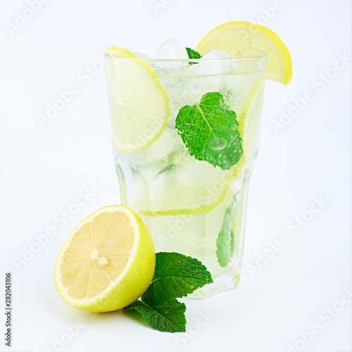 Mojito cocktail with lemon and mint in highball glass, isolated on a white background.