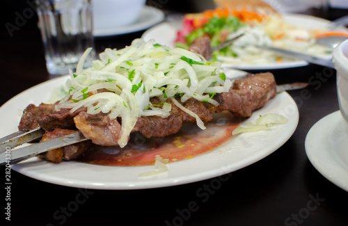 Beautiful shish kebab or shashlik on skewers served at small asian cafe