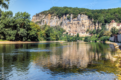 La Roque Gageac  one of France s most beautiful villages by the Dordogne River   backed by a steep hill   cliff  Malartrie Castle in the background. Travel France.