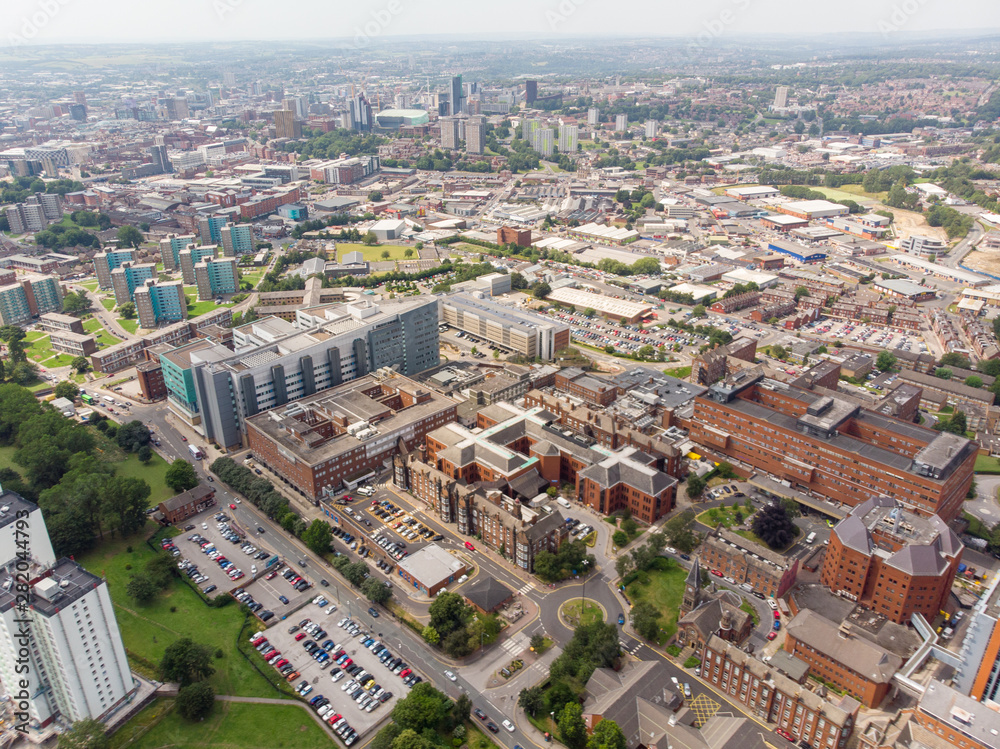 Aerial photo of the St. James's University Hospital in Leeds, West Yorkshire, England, showing the Hospital, A&E entrance and grounds and also the Leeds City Centre in the background on a sunny day.