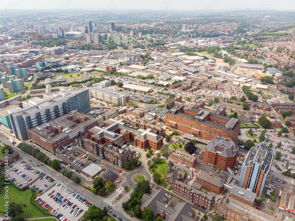 Aerial photo of the St. James's University Hospital in Leeds, West Yorkshire, England, showing the Hospital, A&E entrance and grounds and also the Leeds City Centre in the background on a sunny day.