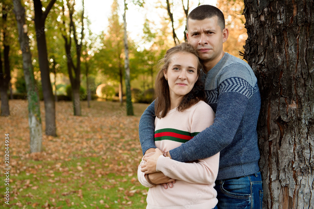 Happy Couple in Autumn Park. Fall. Young Family Having Fun