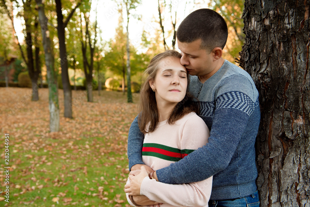 Happy Couple in Autumn Park. Fall. Young Family Having Fun Happy Couple in Autumn Park. Fall. Young Family Having Fun