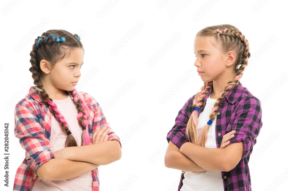 Kids sisters looks strictly. Girls folded arms on chest looks serious white background. Stubborn temper. Stubborn concept. Stubborn kids. Disagreement and stubbornness. Girls offended friends Kids sisters looks strictly. Girls folded arms on chest looks serious white background. Stubborn temper. Stubborn concept. Stubborn kids. Disagreement and stubbornness. Girls offended friends