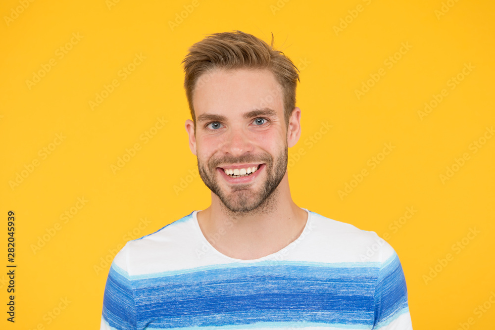 Positive emotions. Happy man on yellow background. Bearded man smiling. Man with mustache and beard happy face expression. Happiness concept. Psychological health. Happy emotional guy close up
