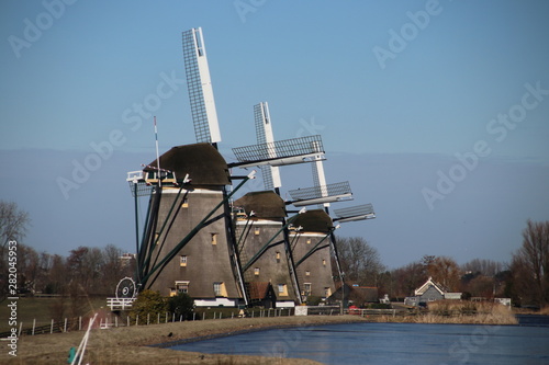 Three windmills on a row in Stompwijk to keep the Driemanspolder on right waterlevel photo