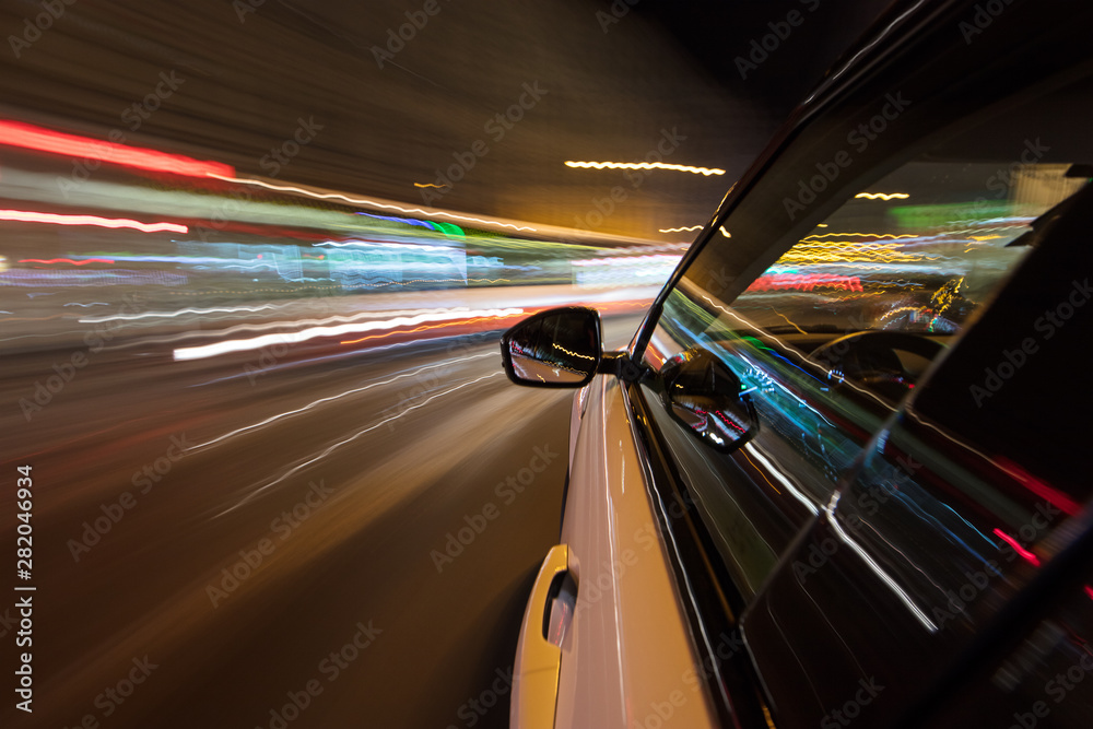 Speeding car driving in a night city.
