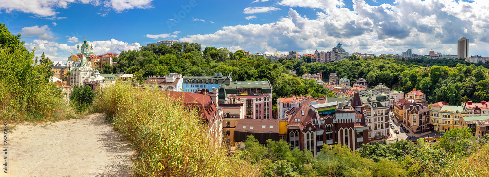 Panorama of historical part of Kyiv city with Andriivska church on Andriyivskyy descent, Vozdvyzhenka with ancient colorful buildings, Ukraine