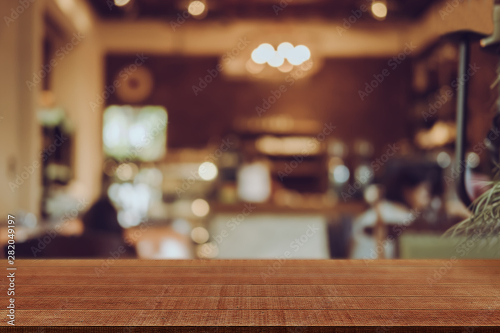 Empty wooden table blurred of restaurant cafe background and reception room, can be used for display or montage your products Empty wooden table blurred of restaurant cafe background and reception room, can be used for display or montage your products