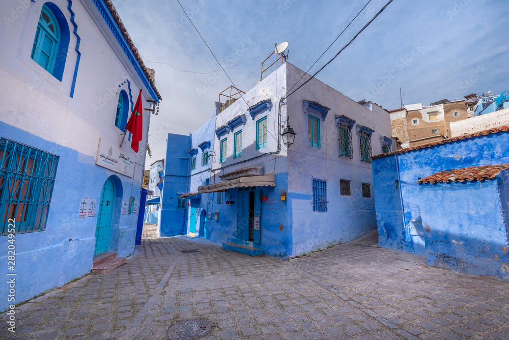 Beautiful view of the blue city Chefchaouen, Morocco in the medina. Traditional moroccan architectural details and painted houses.  street with door and bright blue walls with arch