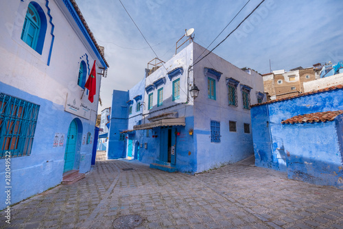 Beautiful view of the blue city Chefchaouen, Morocco in the medina. Traditional moroccan architectural details and painted houses.  street with door and bright blue walls with arch © mitzo_bs
