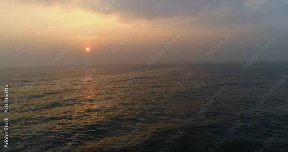 Phantom 4 pro 4 K video of drone rising towards a ocean with a rising sun Phantom 4 pro 4 K video of drone rising towards a ocean with a rising sun