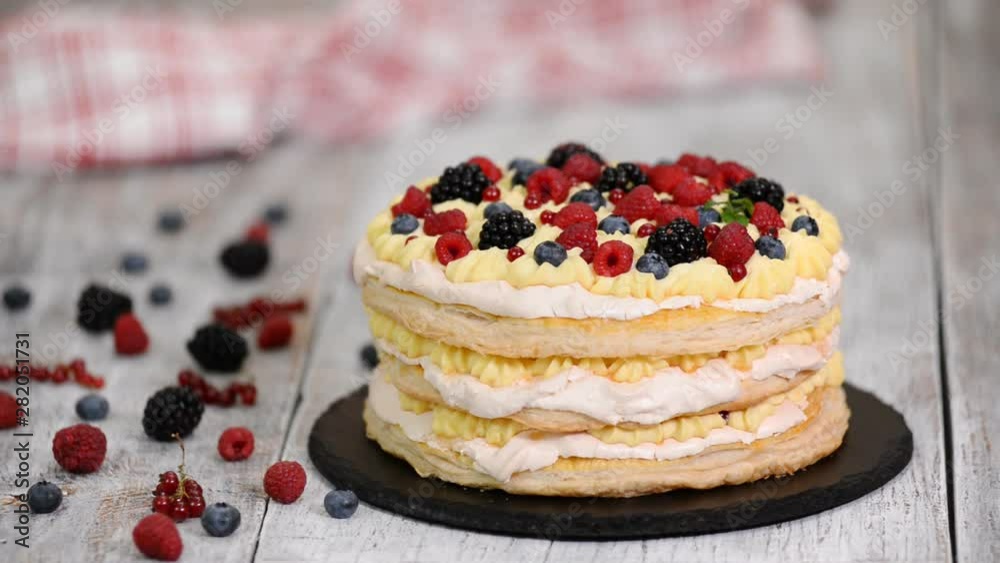 Layered cake decorated with berries and mint. Layered cake decorated with berries and mint.
