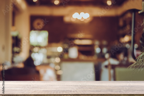 Empty wooden table blurred of restaurant cafe background and reception room, can be used for display or montage your products