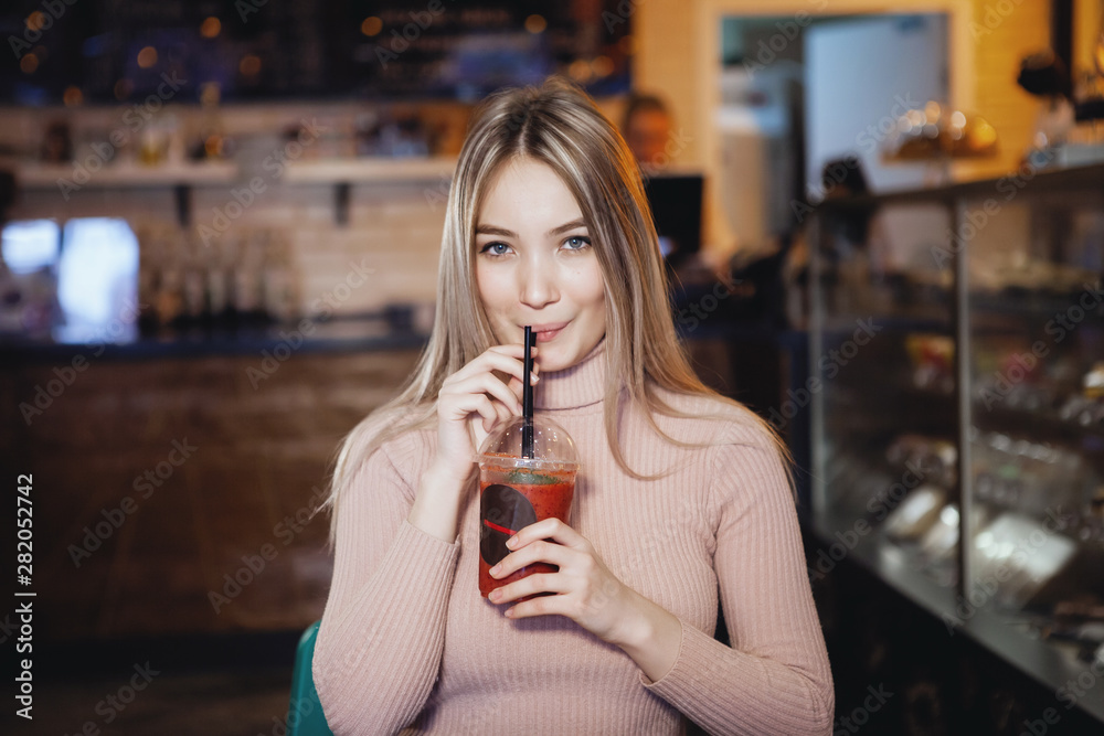 Portrait of beautiful young woman using her digital tablet in cafe.