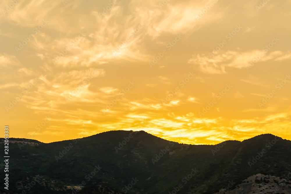 sunset bright sunny yellow light silhouette of the mountain long ridge background nature