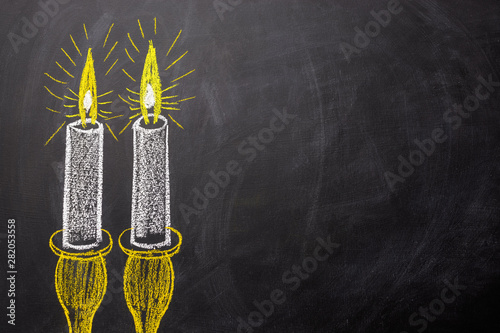 Obraz na płótnie Two candles painted on a chalkboard with copy space. w salonie