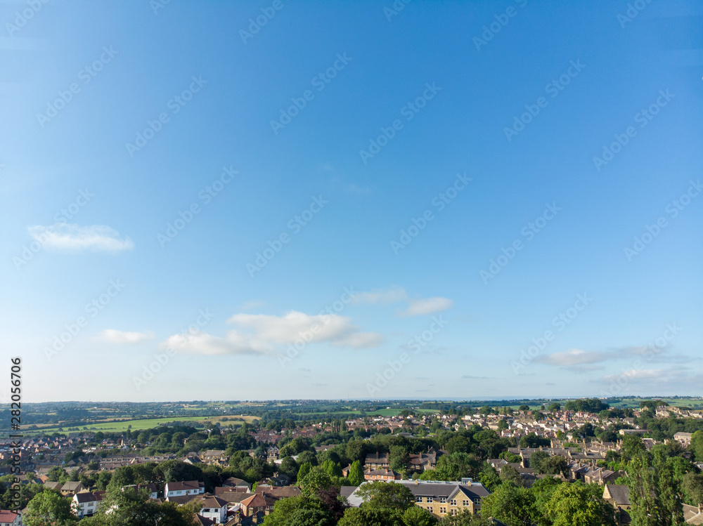 Naklejka premium Aerial photo of the Leeds town of Pudsey in West Yorkshire, England showing typical British streets and business taken on a sunny bright summers day.