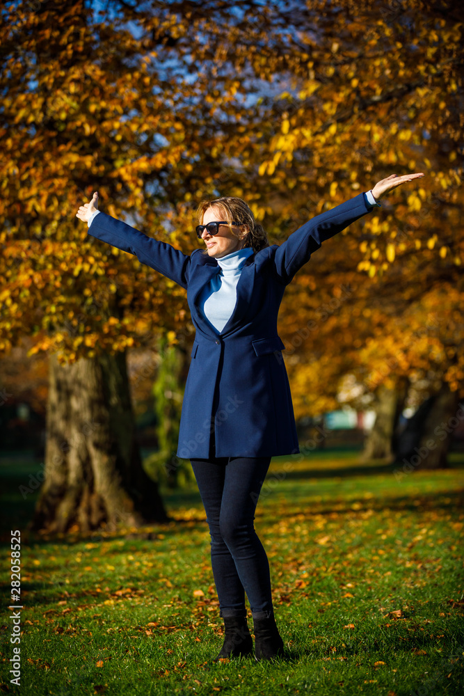 Middle-aged woman walking in city park