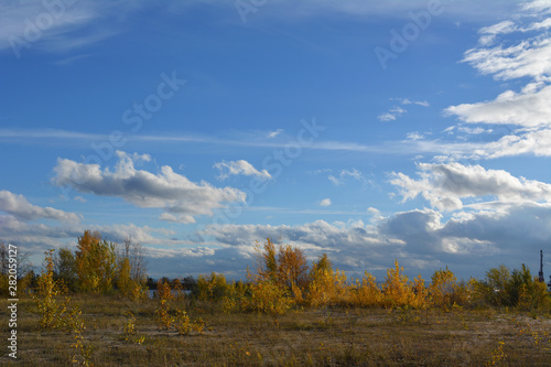 Autumn landscape with golden trees. Panoramic view with beautiful sky.