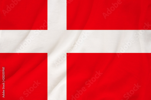 Free Download The national flag of the country of Denmark on the gentle silk with folds from the wind, the concept of travel, immigration, politics, copy space, close-up - GFXLoad