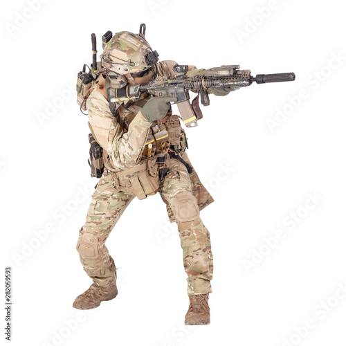 Army soldier crouching with rifle studio shoot photo