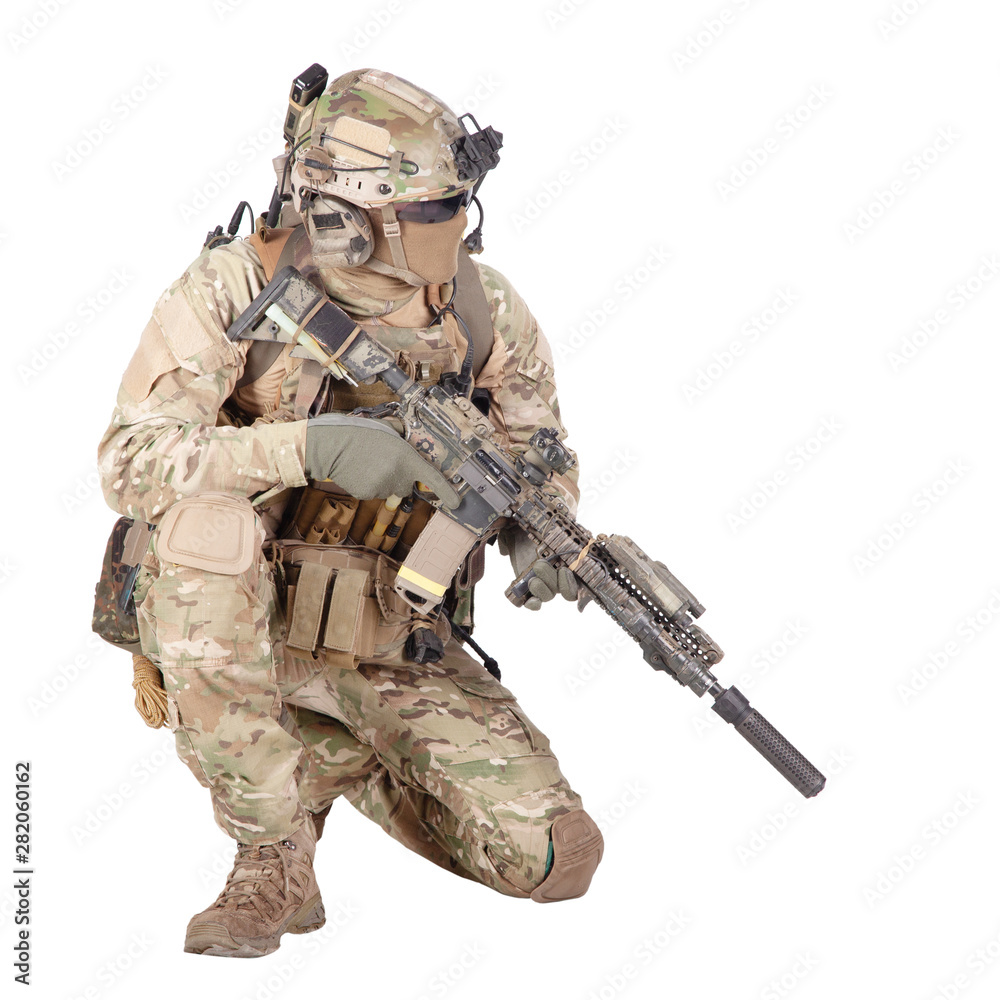 Fototapeta premium Soldier with rifle standing on knee studio shoot
