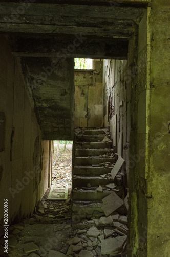 Staircase in an abandoned house. The entrance to the ruined house.