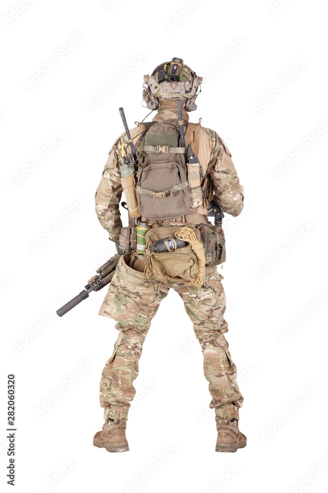 Armed army soldier standing backwards studio shoot Armed army soldier standing backwards studio shoot