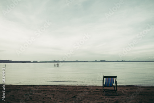 Sea with resort and beach chairs © Johnstocker