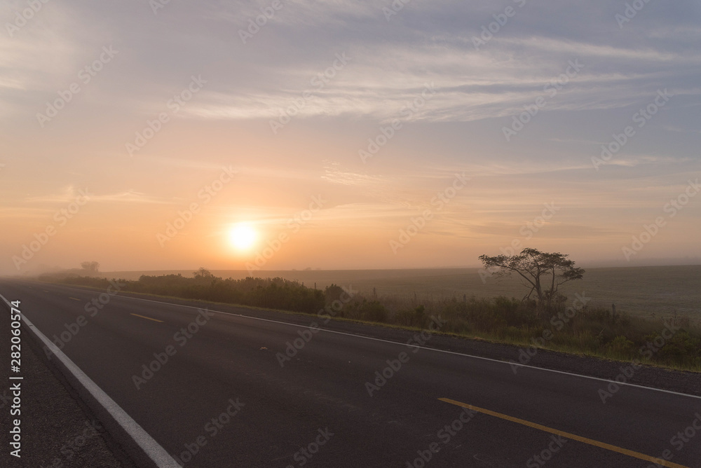 Early morning landscape with sun and fog formation 01