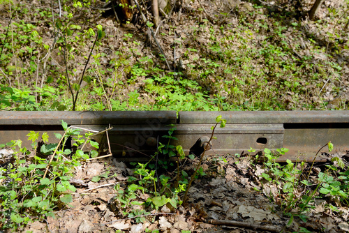 Old rusty rails of an abandoned railway. Side view