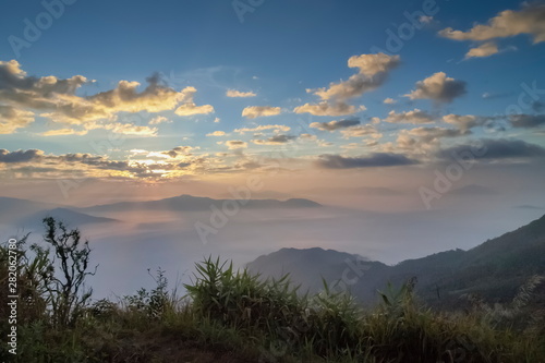 Mountain view misty morning of top hills around with sea of mist with cloudy sky background, sunrise at Pha Tang, Chiang Rai, northern of Thailand.
