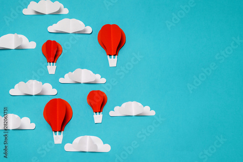 Hot air balloons in the sky paper cut and origami objects. Creative concept for banner landing background designs.