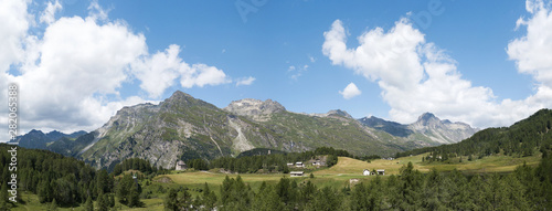 Panorama of beautiful landscape by drone over the Alps mountain height in sunny summer season