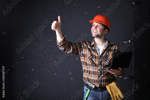 Male architect builder in a protective helmet