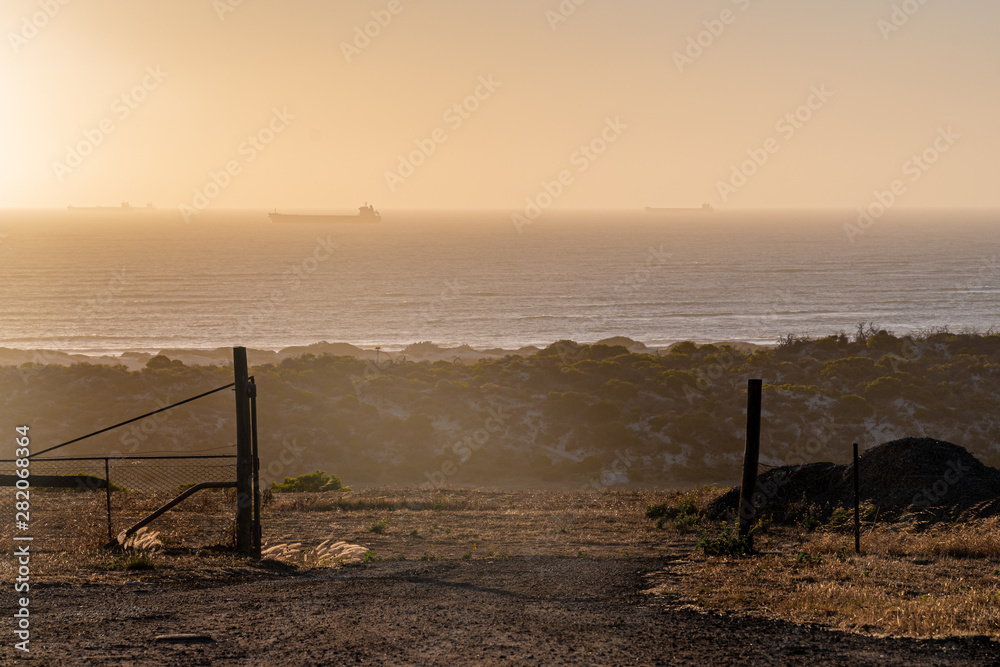 Fence in front of Indian Ocean in Geraldton Western Australia during sunset