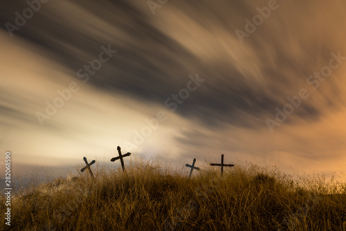 The spirit on Halloween Night flying over a cemetery. Dramatic sky with moon, clouds and stars.