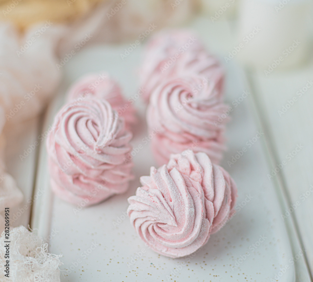 Meringue zephyr marshmallows on a light background. Pink sweet homemade marshmallow. meringue on white background.